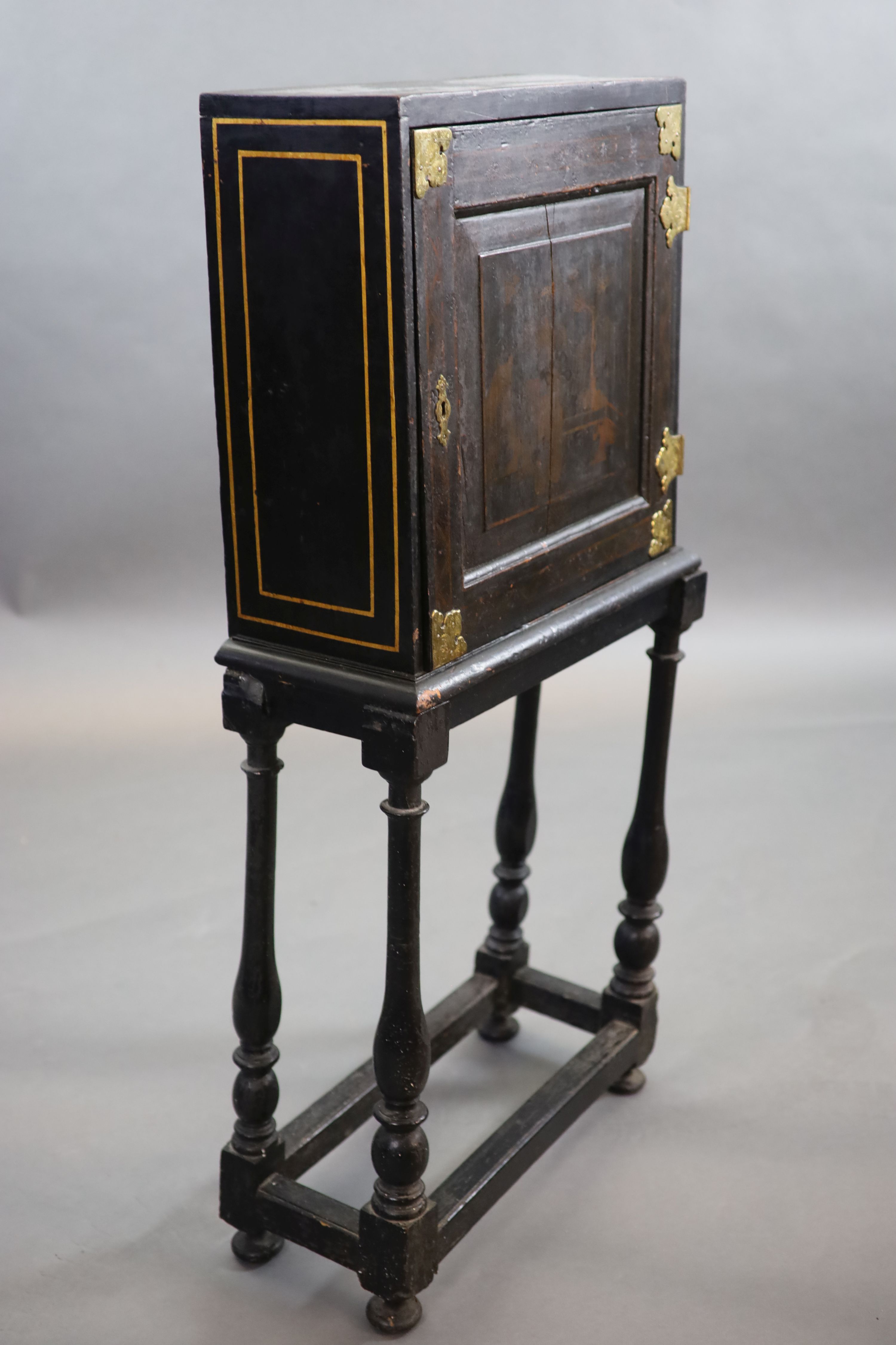 An early 18th century European japanned cabinet on stand, W.54cm D.24cm H.115.5cm